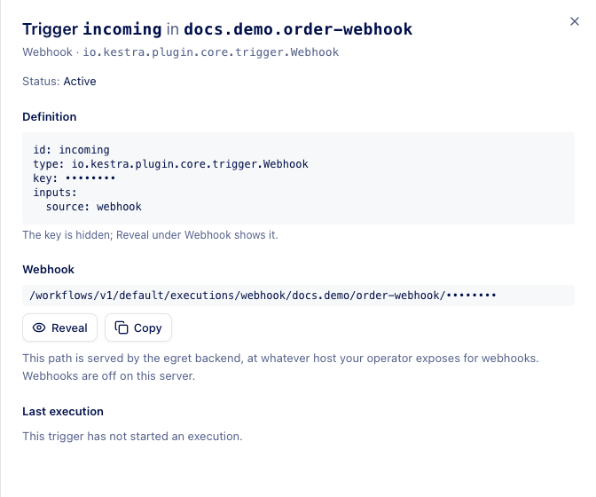 The details drawer of a webhook trigger with the key hidden and the Reveal and Copy buttons